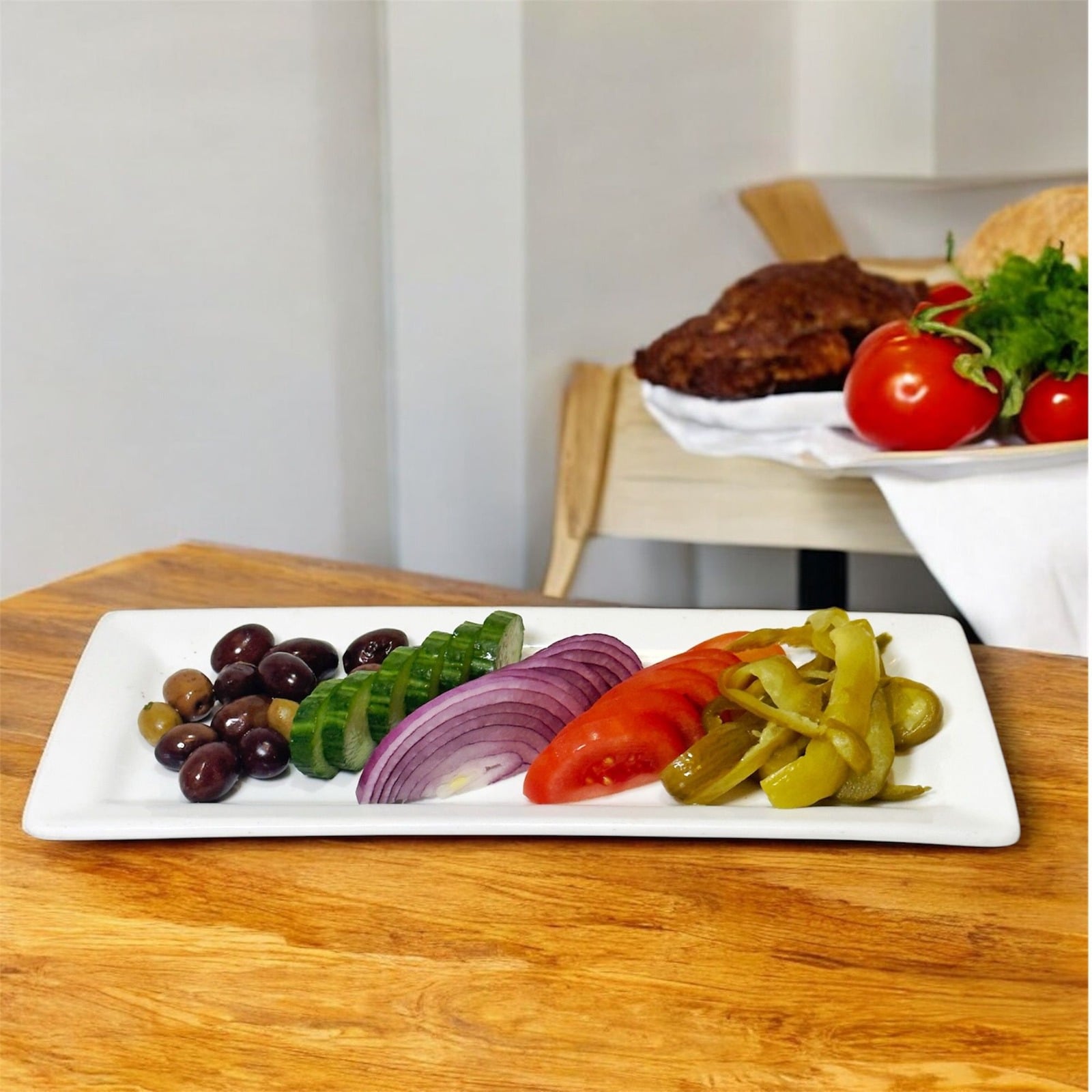 Plate of olives, cucumber, onion, tomato and pickles